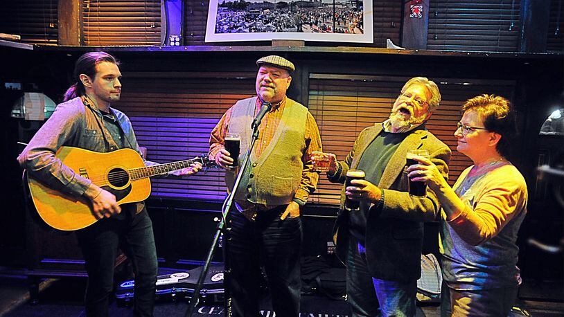 The group Jameson’s Folly played Irish tunes at the Dublin Pub Sunday night as the bar closed at 9 p.m. due to a order by Governor. MARSHALL GORBY/STAFF