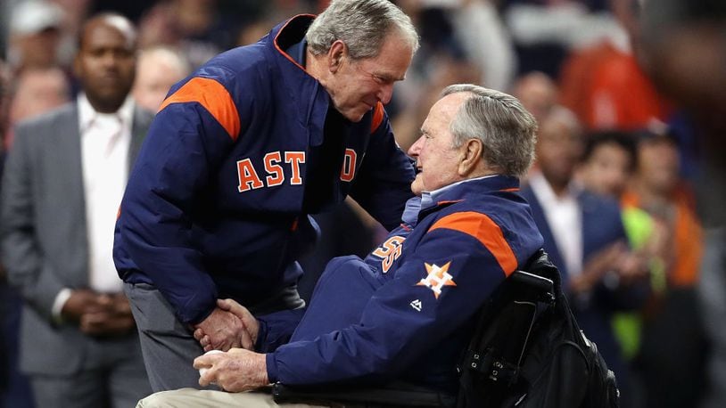 Former presidents George H.W. Bush (right) and George W. Bush prepare to throw out the ceremonial first pitch before Game 5 of the 2017 World Series at Minute Maid Park  in Houston.