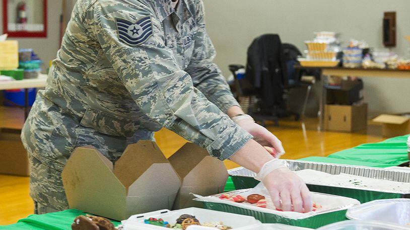 Tech. Sgt. Season Hurley, 88th Medical Support Squadron, packs an assortment of homemade cookies into boxes Dec. 6, 2017, at the Wright-Patterson Air Force Base USO Community Center during the annual cookie drive. Boxes of donated cookies are to be distributed this holiday season to some 1,100 unaccompanied Airmen. (U.S. Air Force photo/R.J. Oriez)