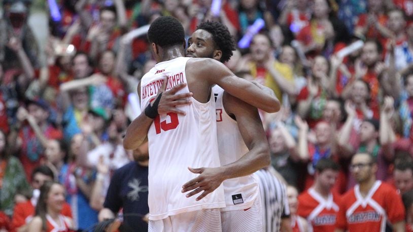 Dayton's Kostas Antetokounmpo and Josh Cunningham hug after a victory against Saint Louis on Tuesday, Feb. 20, 2018, at UD Arena.