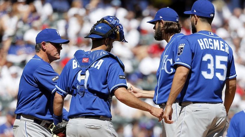 Kansas City Royals manager Ned Yost, left, takes the ball from starting pitcher Jason Hammel, right rear, in the fourth inning of a baseball game against the Texas Rangers as Drew Butera (9) and Eric Hosmer (35) stand on the mound in Arlington, Texas, Sunday, April 23, 2017. (AP Photo/Tony Gutierrez)