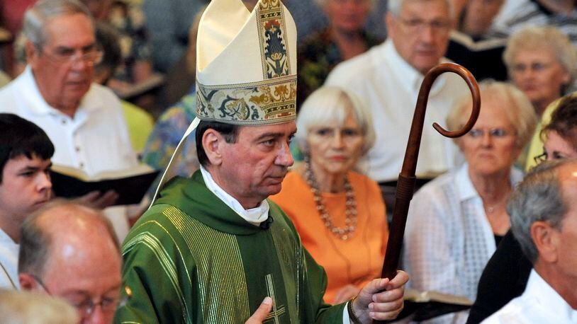 Archbishop Dennis Schnurr walks with the processional at St. Bernard Catholic Church in 2013. Staff photo by Bill Lackey
