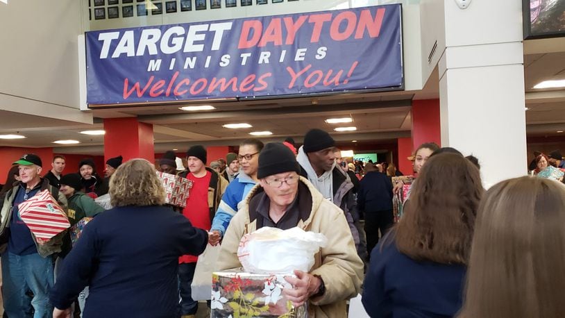 Target Dayton Ministries held its Christmas service at the Dayton Convention Center Wednesday, Dec. 25, 2019, and volunteers greeted attendees as they entered the venue, then worked to distribute 2,200 box lunches and gift boxes as they exited. ERIC SCHWARTZBERG/STAFF