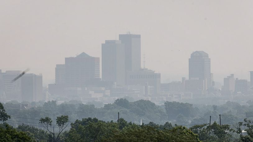 Persisting smoke from Canadian wildfires, shown shrouding downtown Dayton on Tuesday, June 6, 2023, has caused air pollution and extended air quality alerts for the region. JIM NOELKER/STAFF