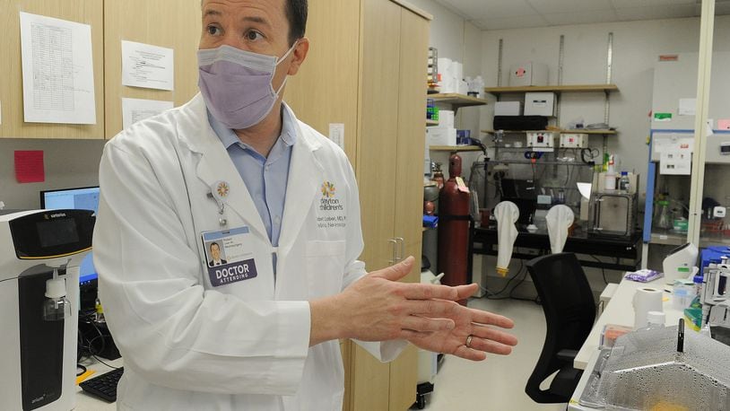 Dr. Robert Lober, at Dayton Children’s, collects brain tumor tissue and then keeps it at a living biobank. By keeping the brain tumors alive, researchers can come back again and again for a sample, trying new therapies and treatments. MARSHALL GORBY\STAFF