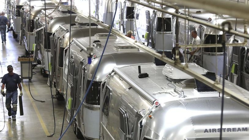 Workers check the interiors of different Airstream Trailers while they move from their placement on the chassis to the installation of the interior furniture parts at the Airstream, Inc. Factory in Jackson Center, Ohio. The trailers are world renowned for their durability and retro style. (Columbus Dispatch photo by Brooke LaValley)