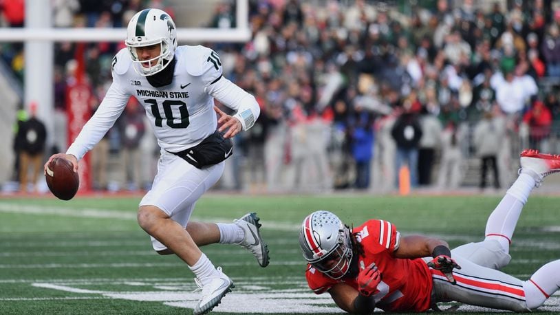 COLUMBUS, OH - NOVEMBER 11:  Quarterback Messiah deWeaver #10 of the Michigan State Spartans is tripped up on fourth down by Chase Young #2 of the Ohio State Buckeyes in the fourth quarter at Ohio Stadium on November 11, 2017 in Columbus, Ohio. Ohio State defeated Michigan State 48-3.  (Photo by Jamie Sabau/Getty Images)