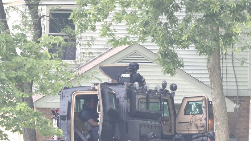Members of the Springfield Police Division surround a house on South Lowry Avenue Monday, June 6, 2022. BILL LACKEY / STAFF