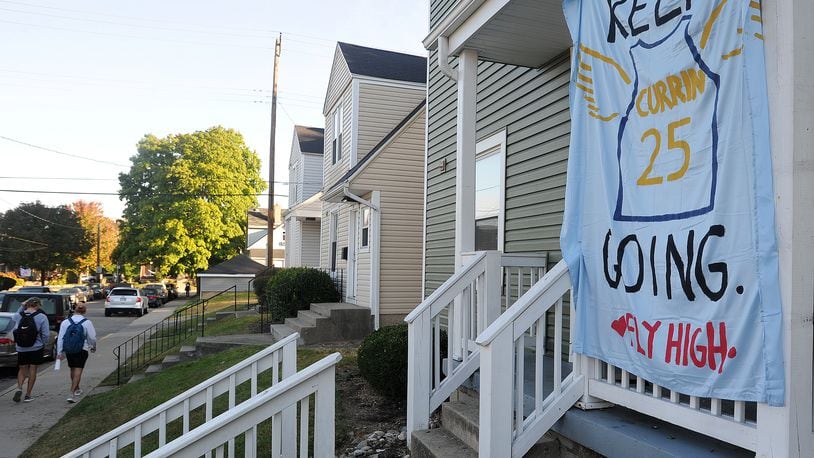 Many houses on the University of Dayton campus display decorated sheets as a tribute to student Michael Currin, who dies Sept. 21. Police say he fell from the bed of a pickup truck and died several days later from his injuries. MARSHALL GORBY/STAFF