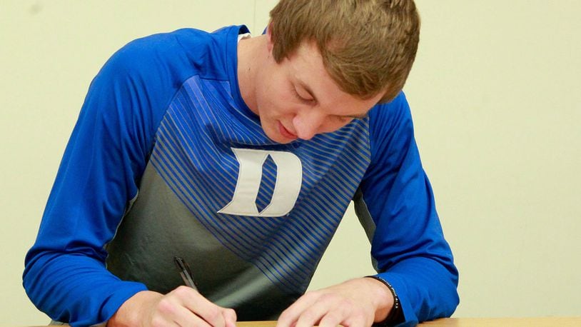 Franklin High School senior Luke Kennard signs his national letter of intent to play basketball at Duke University on Wednesday night in the FHS cafeteria. JIM WITMER/STAFF