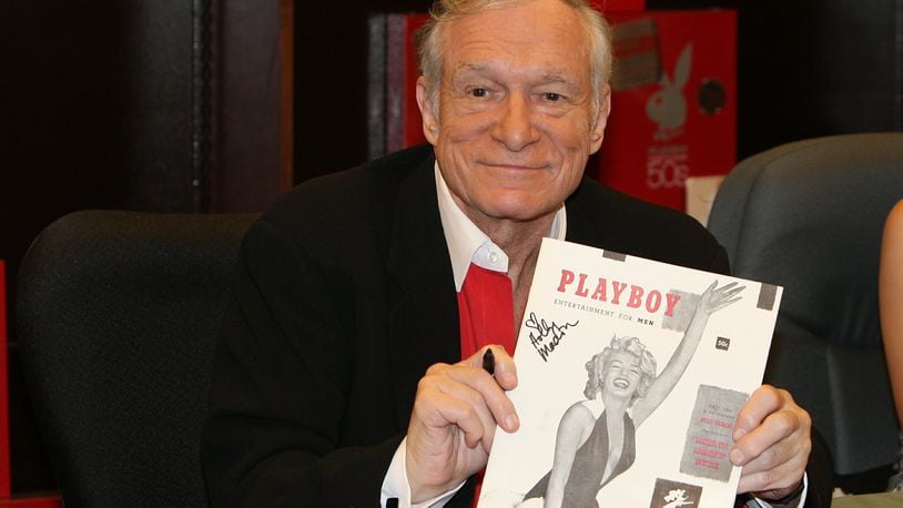 In this Nov. 15, 2007 photo, Hugh Hefner smiles while signing copies of the Playboy calendar and Playboy Cover To Cover: The 50’s DVD box set in Los Angeles. Playboy will no longer publish photos of nude women as part of a redesign of the decades-old magazine, according to a news report Monday, Oct. 12, 2015. Executives for the magazine company told The New York Times that the change will take place in March 2016. Playboy editor Cory Jones contacted founder and current editor in chief Hugh Hefner recently about dropping nude photos from the print edition and he agreed, the Times reported. (Ian West/PA via AP) UNITED KINGDOM OUT NO SALES NO ARCHIVE