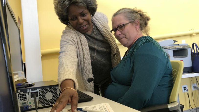 Stella Lee, 68, works at the Goodwill Easter Seals in Dayton, along with Maria Wogoman, the program manager for the Senior Citizen Service Employment Program. KARA DRISCOLL/STAFF