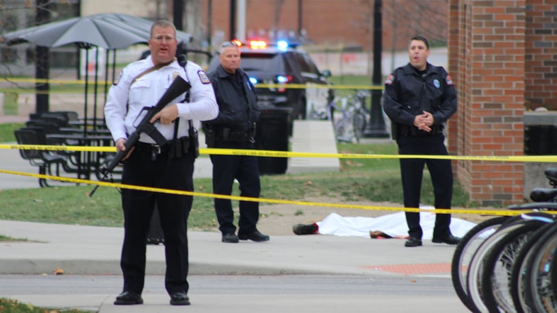 Officers stand near a body lying near the Chemical and Biomolecular Engineering Chemistry building. MASON SWIRES/TheLantern.com