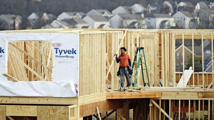 A crew works on construction of a new home on Elm Leaf Trail in 2017 in Liberty Twp.’s Aspen Trails subdivision, just north of Kyles Station Road. STAFF FILE PHOTO