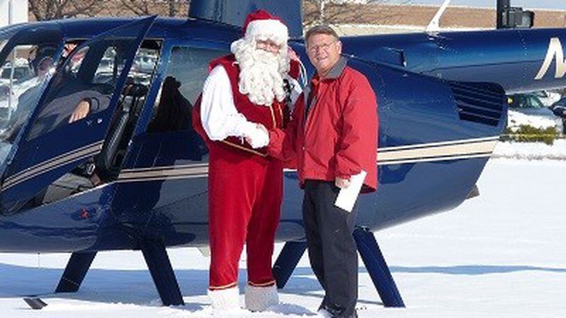 Santa Claus will be delivered by helicopter to visit the Dayton Mall Skyline Chili at 8906 Kingsridge Drive  for a meet-and-greet event with families from noon to 2 p.m. on Saturday, Dec. 7. In this submitted 2017 photo, Santa is shown with Mark Keilholz, franchise owner of the Kingsridge Drive Skyline restaurant.