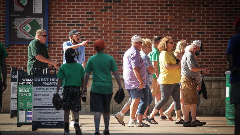 Dragons fans enter the ballpark Tuesday evening, May 25, 2021, after spending some time in the hot spring sun. It was the warmest day of the year so far with the high temperature reported at 88 degrees in Dayton and Cincinnati, which is more than 10 degrees above normal. JIM NOELKER / STAFF