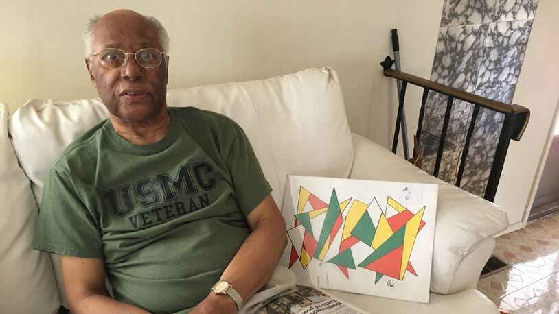 George Woods has been a loyal subscriber to the Dayton Daily News since 1960. He is also an artist of colorful, geometric pieces like the one pictured to his right. STAFF PHOTO / SARAH FRANKS