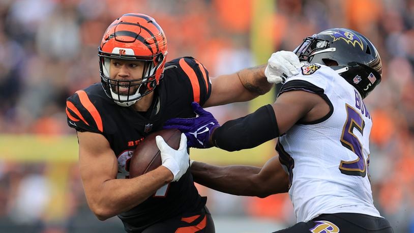 Cincinnati Bengals' C.J. Uzomah, left, is tackled by Baltimore Ravens' Tyus Bowser (54) during the second half of an NFL football game, Sunday, Dec. 26, 2021, in Cincinnati. (AP Photo/Aaron Doster)