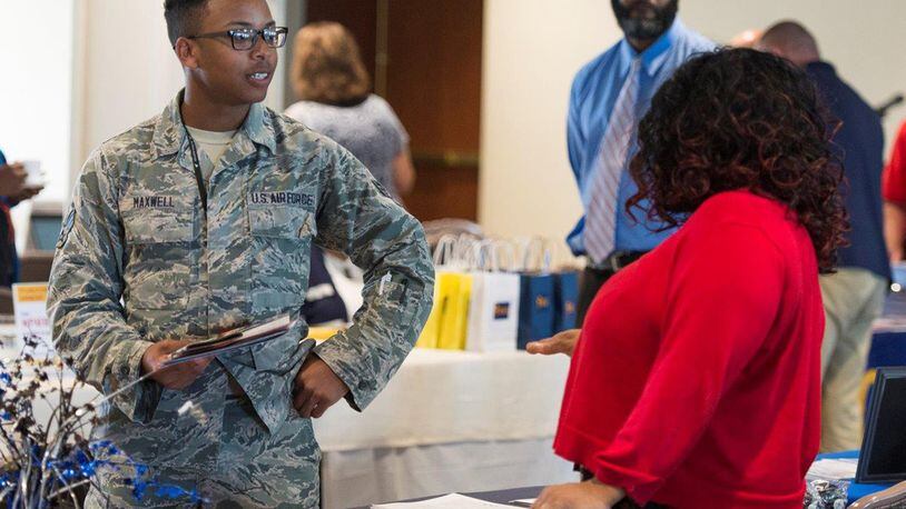 Senior Airman Kenaan Maxwell, National Air and Space Intelligence Center Intelligence operations analyst, talks with Deunka Hampton, a representative of Xavier University, during the 2018 Wright-Patterson Air Force Base Development, Education and Training Exposition July 12 at the Wright-Patterson Club. During the expo, civilians and military personnel were able to talk with different college representatives and attend briefings on education-based topics. (U.S. Air Force photo/Wesley Farnsworth)
