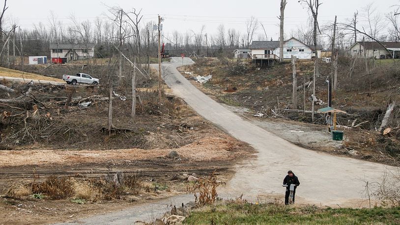 Aaron Krueger could barely see neighbors’ homes from his on Murwood Court in Beavercreek before the Memorial Day tornadoes swept through heavily wooded Grange View Acres. Now some of the homes are gone and others are in plain view. CHRIS STEWART / CMGO STAFF