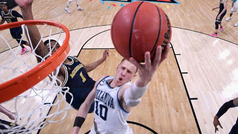 SAN ANTONIO, TX - APRIL 02: Donte DiVincenzo #10 of the Villanova Wildcats drives to the basket against Charles Matthews #1 of the Michigan Wolverines in the second half during the 2018 NCAA Men's Final Four National Championship game at the Alamodome on April 2, 2018 in San Antonio, Texas.  (Photo by Jamie Schwaberow - Pool/Getty Images)