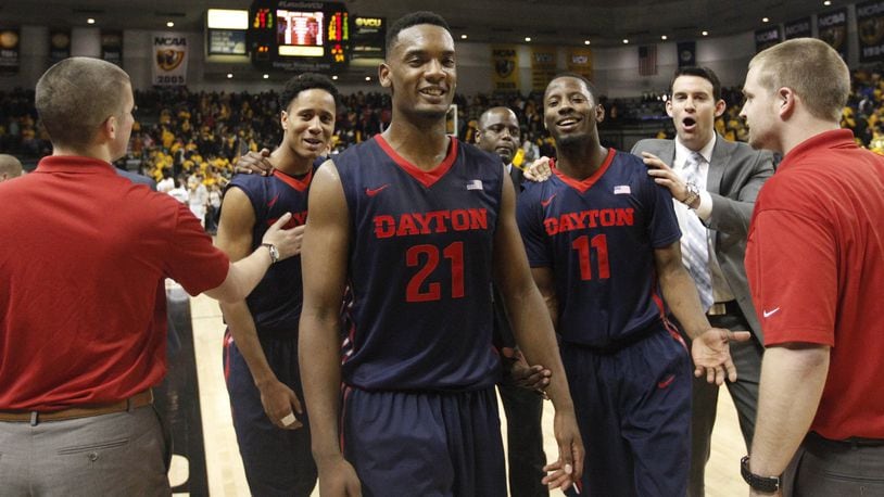 Dayton’s Dyshawn Pierre and the Flyers leave the court after a victory against Virginia Commonwealth on Saturday, Feb. 28, 2015, at the Siegel Center in Richmond, Va. David Jablonski/Staff
