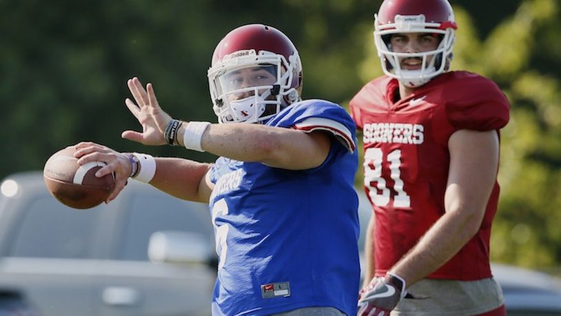 In this Aug. 3, 2017, file photo, Oklahoma quarterback Baker Mayfield, left, throws in front of tight end Mark Andrews (81) during an NCAA college football practice in Norman, Okla. Oklahoma, with Heisman Trophy finalist quarterback Mayfield back for his senior season, will be going for its third consecutive Big 12 title, and 11th overall. (AP Photo/Sue Ogrocki, File)