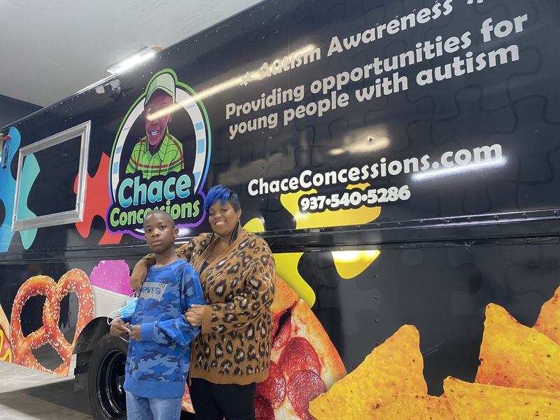 Dayton entrepreneur Tae Winston (right) gifted a food truck to her 11-year-old son, Chace, who has autism. The truck, which was presented to the boy at Performance Wraps in Miamisburg Monday, Dec. 13, 2021. It will employ people with autism, raising awareness of the developmental disorder and raising funds for the Dayton Autism Society. ERIC SCHWARTZBERG/STAFF