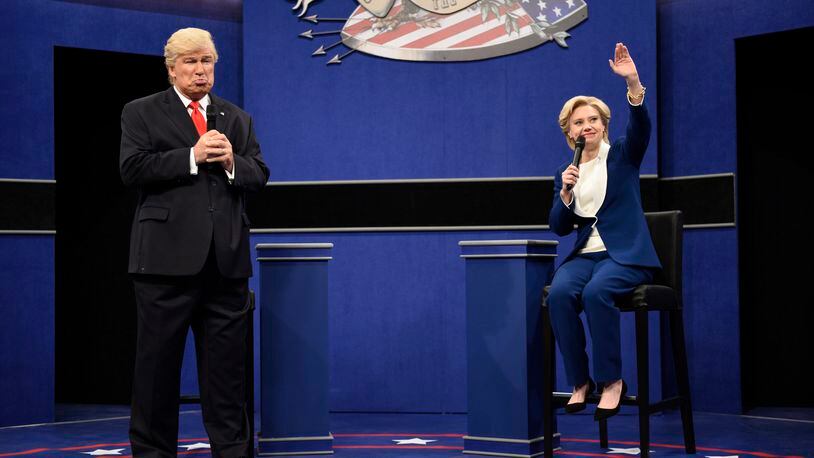 In this Oct. 15, 2016 photo provided by NBC, Alec Baldwin, left, as Republican presidential candidate, Donald Trump, and Kate McKinnon, as Democratic presidential candidate, Hillary Clinton, perform during the during the "Debate Cold Open" sketch. Republican presidential candidate Donald Trump tweeted early Sunday morning, Oct. 16 that the show’s skit depicting him this week was a “hit job.” Trump went on to write that it’s “time to retire” the show, calling it “boring and unfunny” and adding that Alec Baldwin’s portrayal of him “stinks.”(Will Heath/NBC via AP)