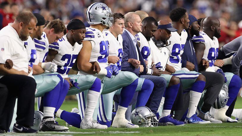 GLENDALE, AZ - SEPTEMBER 25:  Members of the Dallas Cowboys link arms before the National Anthem at the start of the NFL game against the Arizona Cardinals at the University of Phoenix Stadium on September 25, 2017 in Glendale, Arizona.  (Photo by Christian Petersen/Getty Images)
