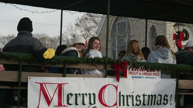 Festival-goers at Christmas in Historic Springboro ride in a horse-drawn cart on Saturday, Nov. 22.