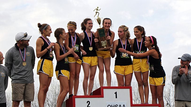 The Centerville Elks celebrate a fourth straight Division I cross country state championship at National Trail Raceway on Saturday. Contributed / Greg Billing