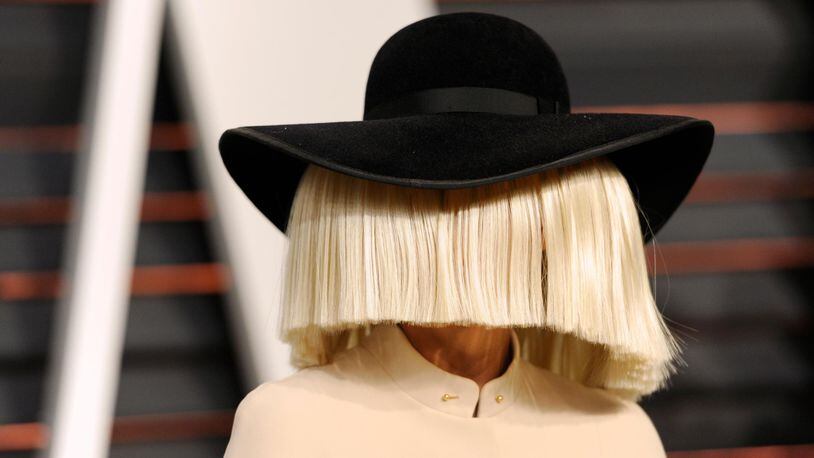 FILE - In this Feb. 22, 2015, file photo, Sia arrives at the 2015 Vanity Fair Oscar Party in Beverly Hills, Calif. Sia tweeted a nude photo of herself on Nov. 6, 2017, after learning that someone was trying to sell nude paparazzi photos of her. (Photo by Evan Agostini/Invision/AP, File)