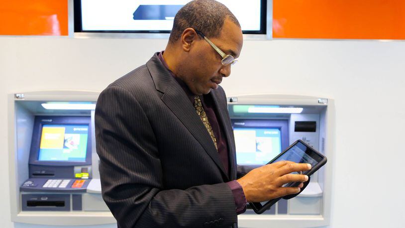 PNC Bank Universal Branch Consultant Kelvin Little demonstrates the Virtual Wallet App on an ipad in this 2015 photo. PNC at the time was debuting what it called its “branch of the future.” FILE