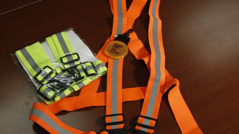 A blinking safety light and reflective belts are shown at the Miami Valley Regional Planning Commission. The MVRPC, ODOT and the City of Dayton are conducting a traffic safety study for North Main Street after several pedestrians have been hit between Great Miami Boulevard and Shiloh Springs Road. TY GREENLEES / STAFF