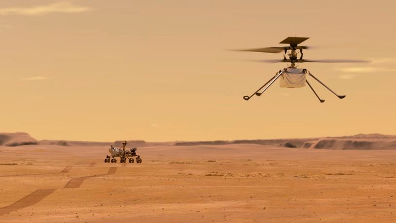 This illustration made available by NASA depicts the Ingenuity helicopter on Mars after launching from the Perseverance rover, background left. It will be the first aircraft to attempt controlled flight on another planet. (NASA/JPL-Caltech via AP)