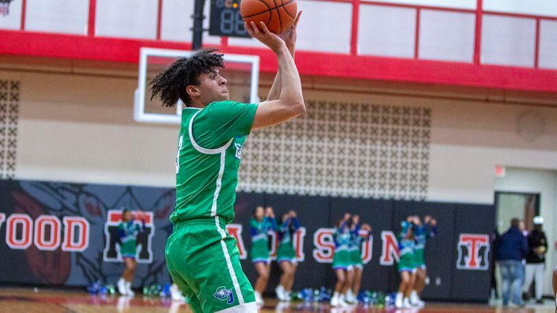 Chaminade Julienne senior George Washington III shoots for two of his game-high 24 points in Saturday night's season opener at Trotwood-Madison. CONTRIBUTED/Jeff Gilbert