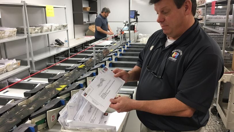 Sometimes absentee ballots arrive without the proper information or a signature. Those are separated out and voters are notified via mail and given a chance to correct the information so their vote can be counted.  In this file photo from 2016 Montgomery County Board of Elections Deputy Director Steve Harsman sorts through problem ballots. LYNN HULSEY/staff