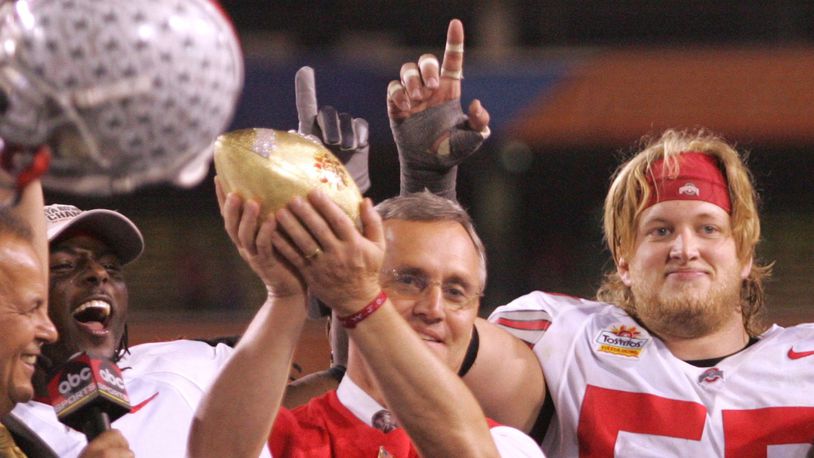 Ohio State coach Jim Tressel holds up the Fiesta Bowl trophy, as Nick Mangold, back right, and the rest of the senior on the stage, hoists the Fiesta Bowl trophy in 2005. Ron Alvey/Staff
