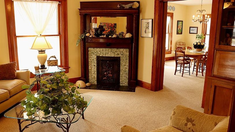 A decorative corner fireplace accents the formal living room, which has pocket doors that open into two other social areas of the main level.