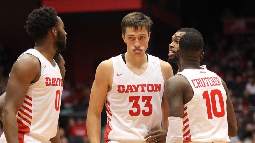 Dayton’s starters, including Ryan Mikesell, center, huddle during an exhibition game against North Florida on Friday, Nov. 2, 2018, at UD Arena.