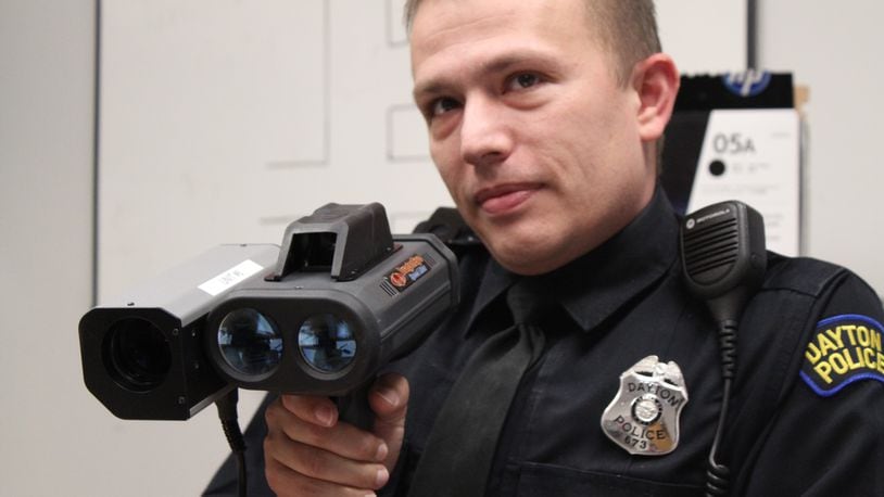 Dayton police Detective Jason Ward, of the department’s crash reconstruction unit, holds a Lidar speed gun. CORNELIUS FROLIK / STAFF