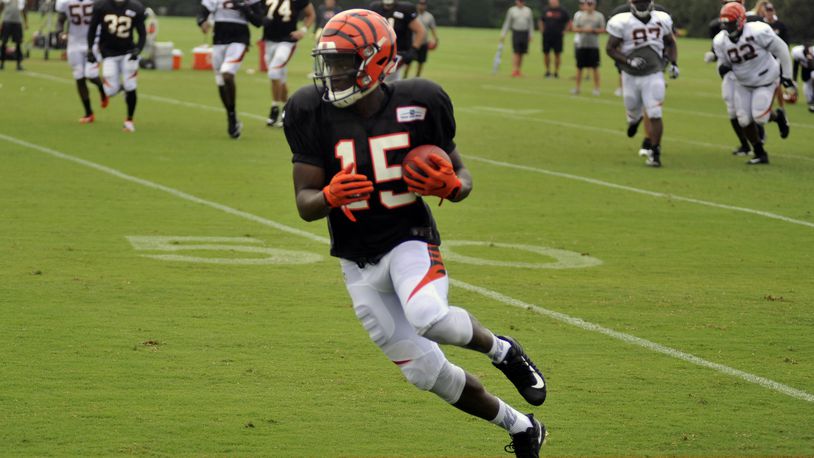 Cincinnati Bengals first-round pick John Ross turns up field after catching a pass in practice Monday, Aug. 14, 2017 at Paul Brown Stadium. Jay Morrison / Staff