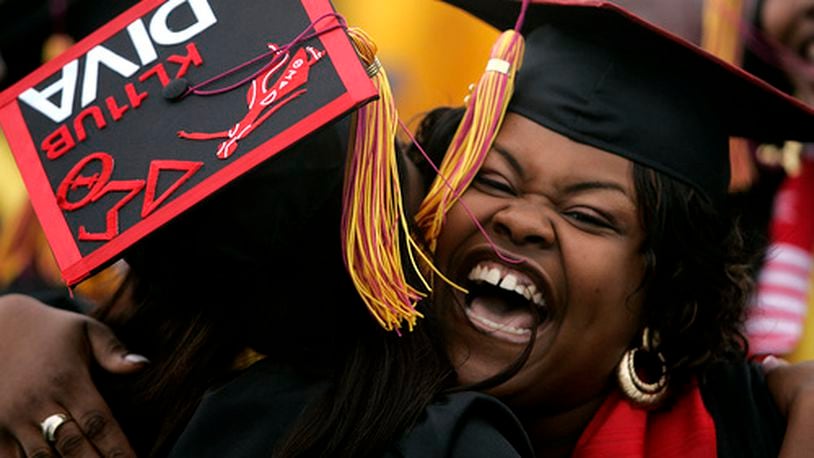 A Central State University graduate gets a hug from a fellow student at the commencement ceremony held at the university Saturday, May 3, 2008.