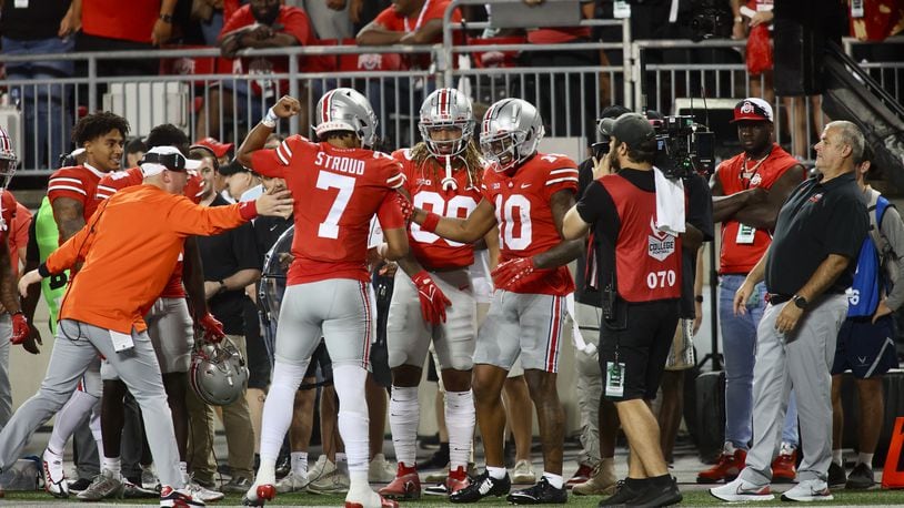 Ohio State's Xavier Johnson, right, celebrates after catching a touchdown pass from C.J. Stroud, left, against Notre Dame on Saturday, Sept. 3, 2022, at Ohio Stadium in Columbus. David Jablonski/Staff