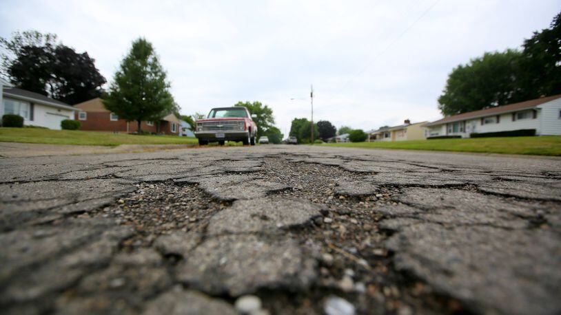 The city of Middletown expects to receive one-time revenue windfalls of $1 million to $2 million in coming years from construction projects. Two options for the money are investment in the East End/Renaissance area near Interstate 75 and Ohio 122, or fix older crumbling streets like Hannah Dr., shown here. GREG LYNCH / STAFF
