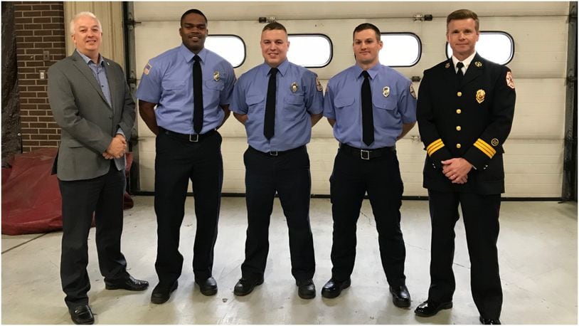 Middletown pinned badges on the city’s newest firefighter-EMTs Thursday at Fire Headquarters. Pictured (from left) are: Middletown City Manager Doug Adkins; firefighter-EMTs Antonio Pittman, Branden Cottrell and Joey Robertson; and Middletown Deputy Fire Chief David Adams. CONTRIBUTED