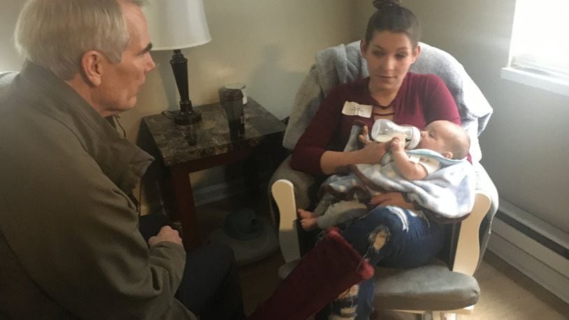 U.S. Senator Rob Portman was in Kettering Monday morning as he paid a visit to the Promise to Hope Maternal Recovery Housing program. He is shown with Amanda Blake and her baby, Xavier.