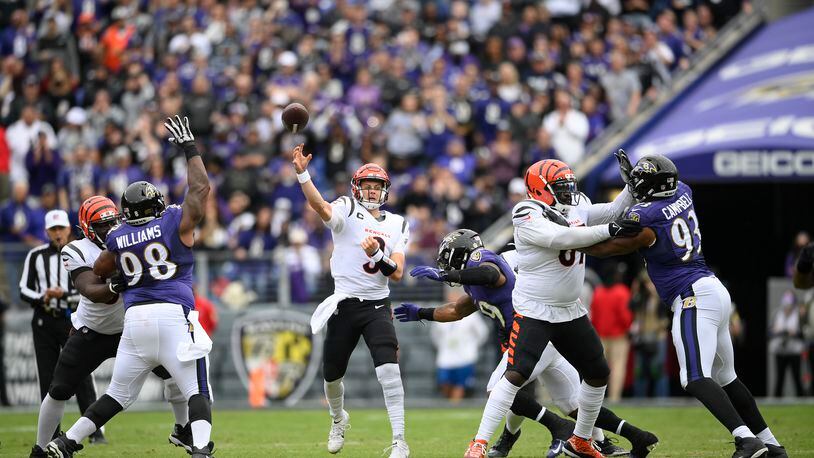 Cincinnati Bengals quarterback Joe Burrow, center, throws a pass against the Baltimore Ravens during the first half of an NFL football game, Sunday, Oct. 24, 2021, in Baltimore. (AP Photo/Nick Wass)
