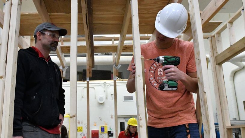 Jim Kitchen, left, watches Tippecanoe High School student work on tiny house to be donated to veterans project. CONTRIBUTED